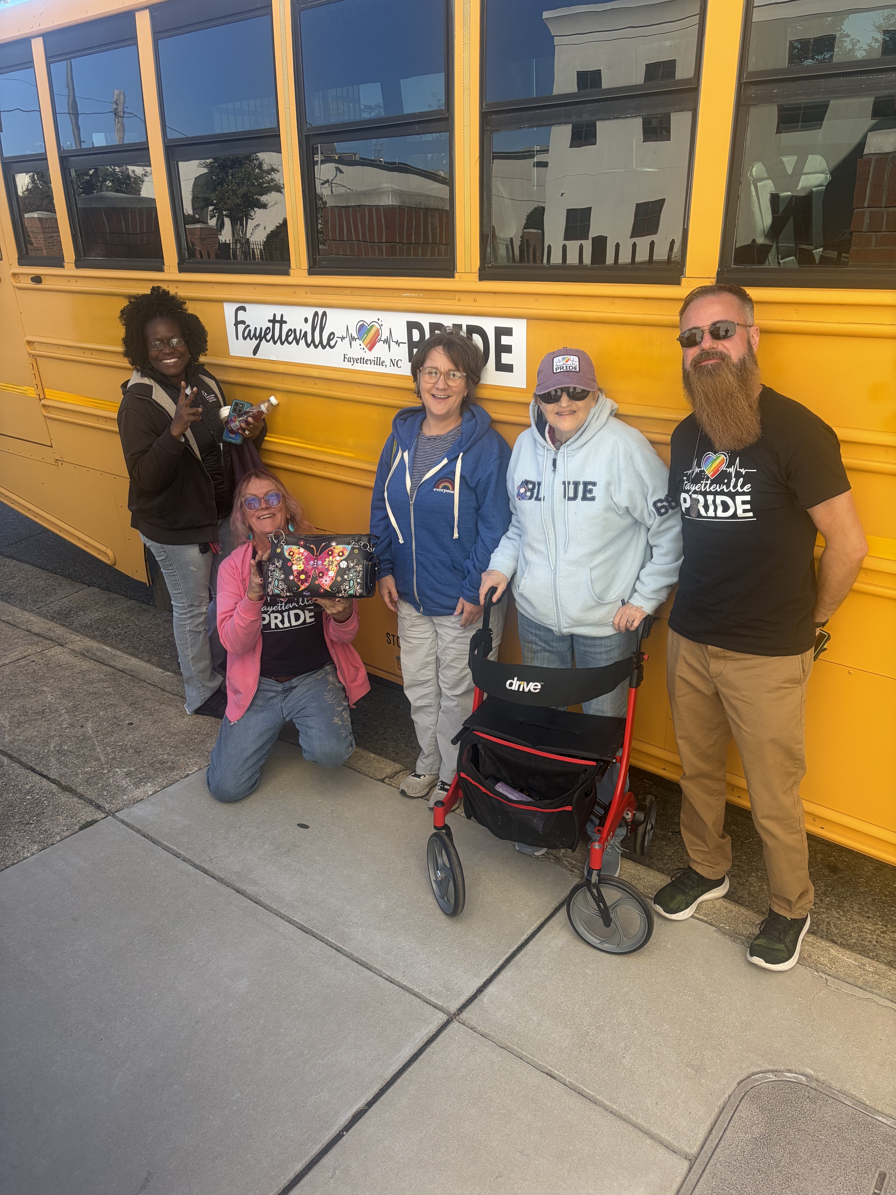 NC State Fair 2026 — group selfie in front of the Fayetteville Pride bus